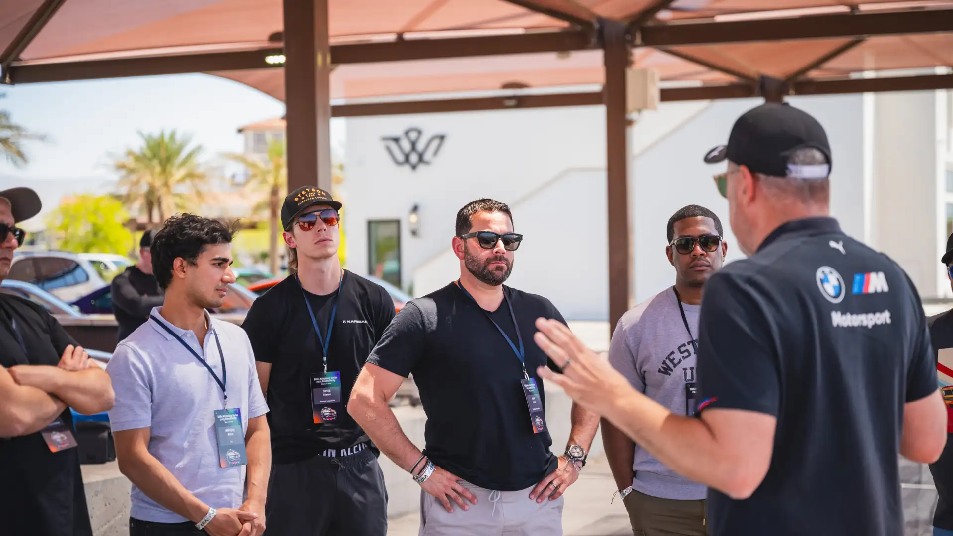Instructor briefing a group of participants under the paddock canopy