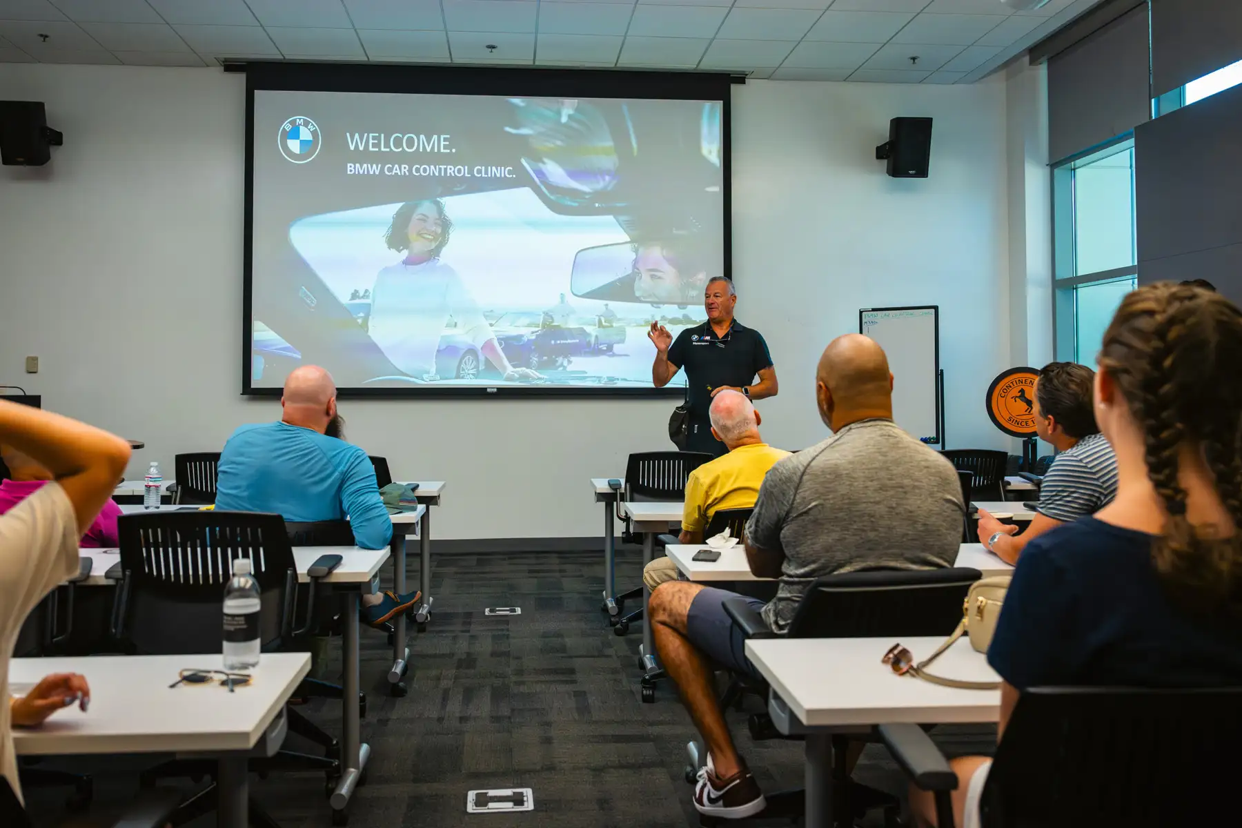 Instructor opening a BMW Car Control Clinic session in the classroom