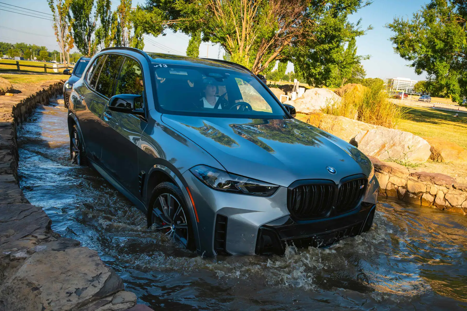 Grey BMW X5 wading through the water crossing