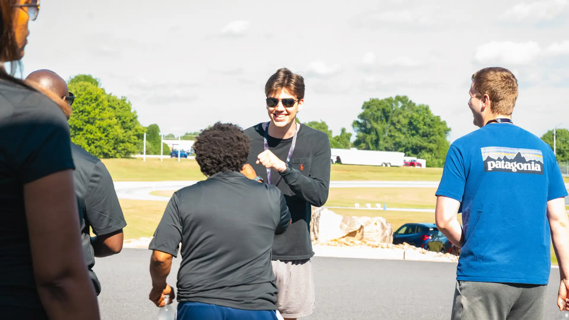 Participants talking and greeting each other beside the track