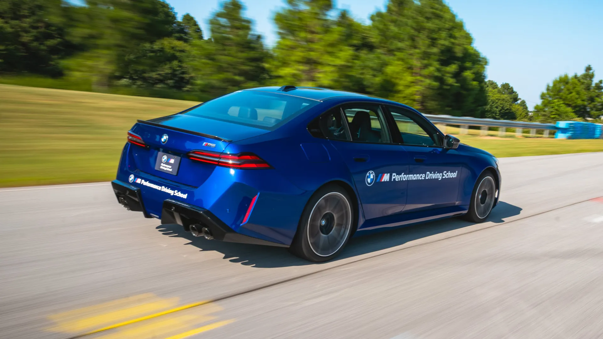 Blue BMW M5 accelerating away along the circuit