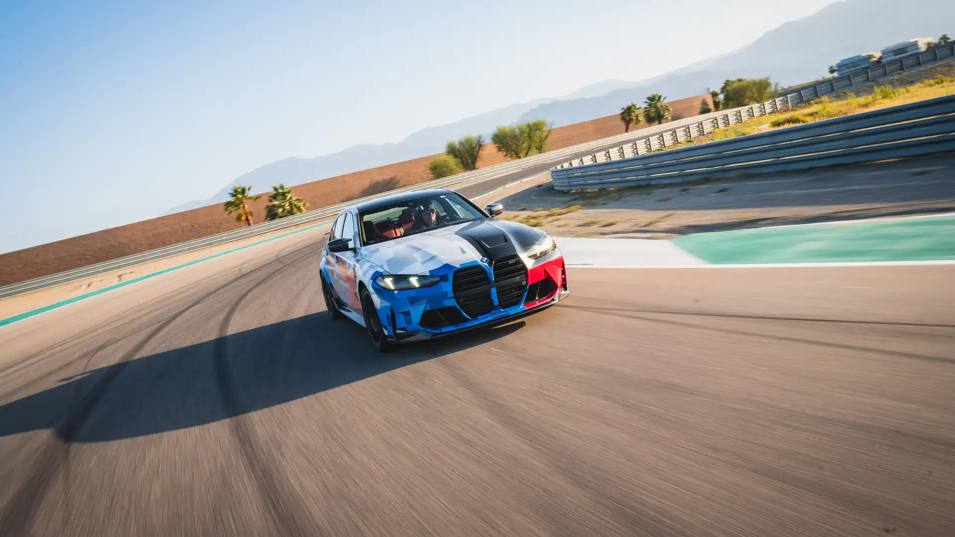 BMW M3 in Motorsport livery cornering on the desert circuit