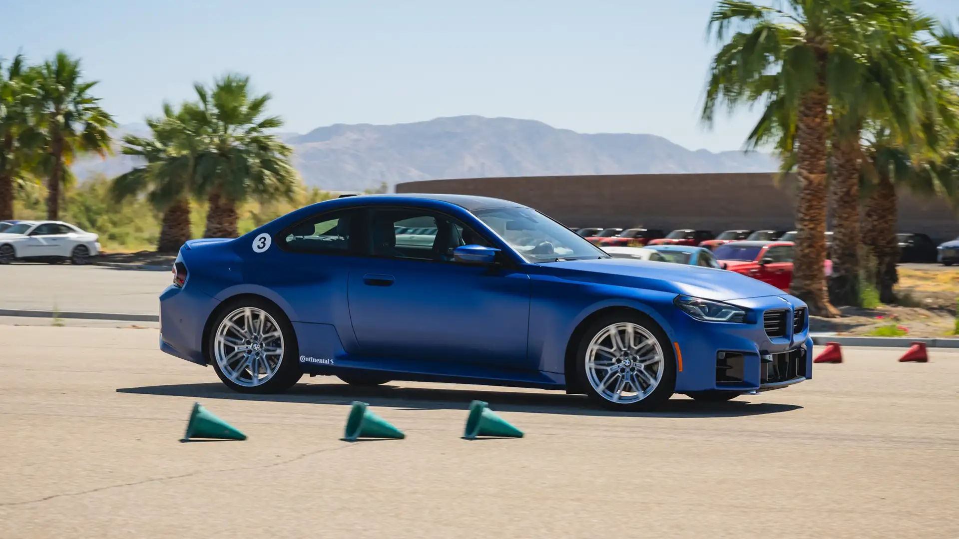 Blue BMW M2 on a coned autocross course