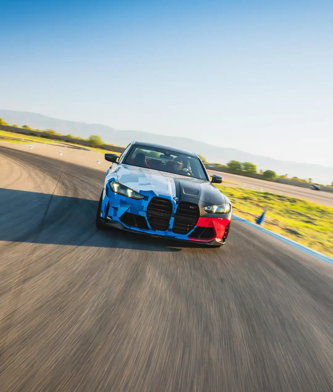 BMW M3 in Motorsport livery cornering on the desert circuit