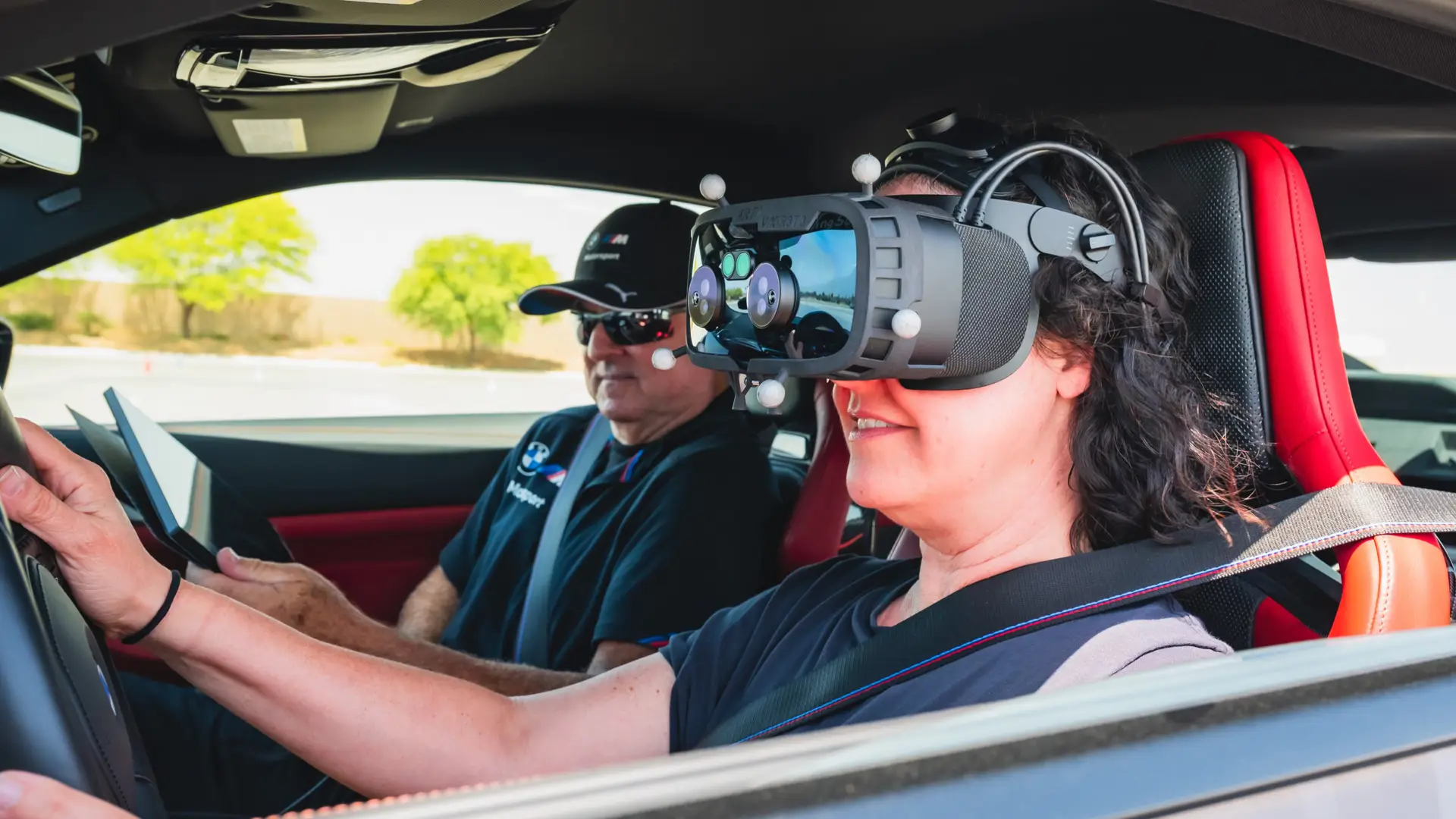 Close-up of a driver smiling behind a mixed-reality headset