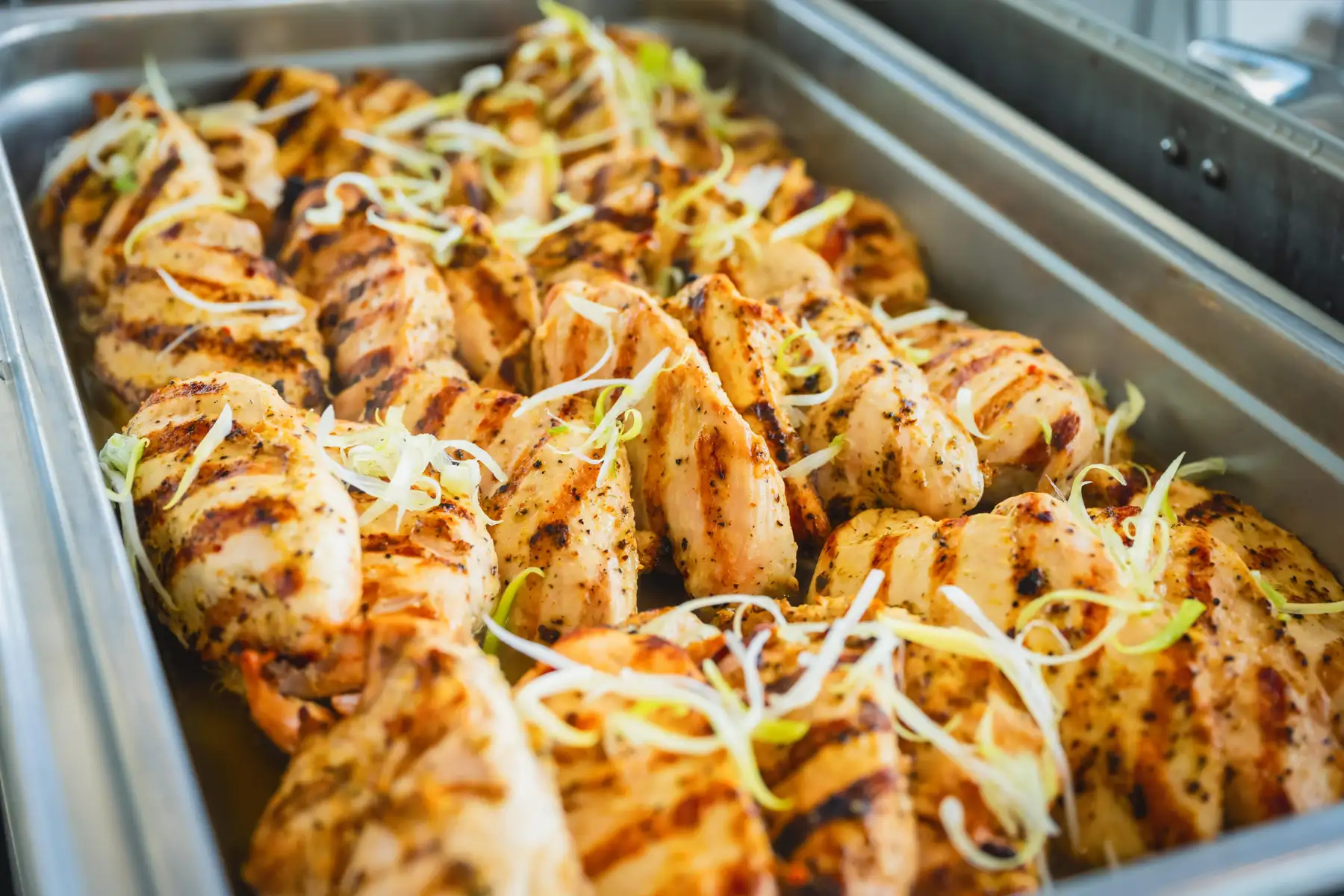 Tray of grilled chicken breasts at a BMW Performance Center catered lunch