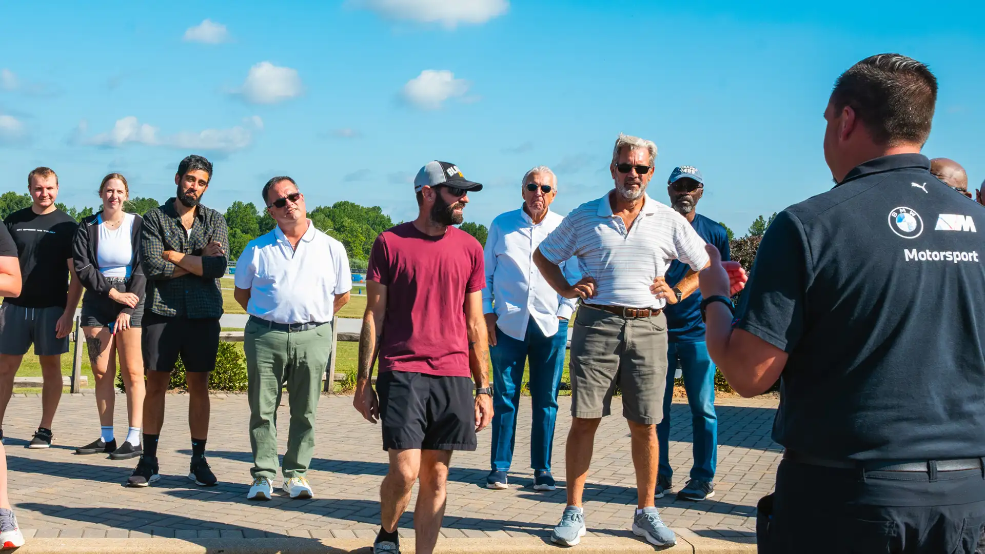 Instructor briefing a group of guests outside the Performance Center