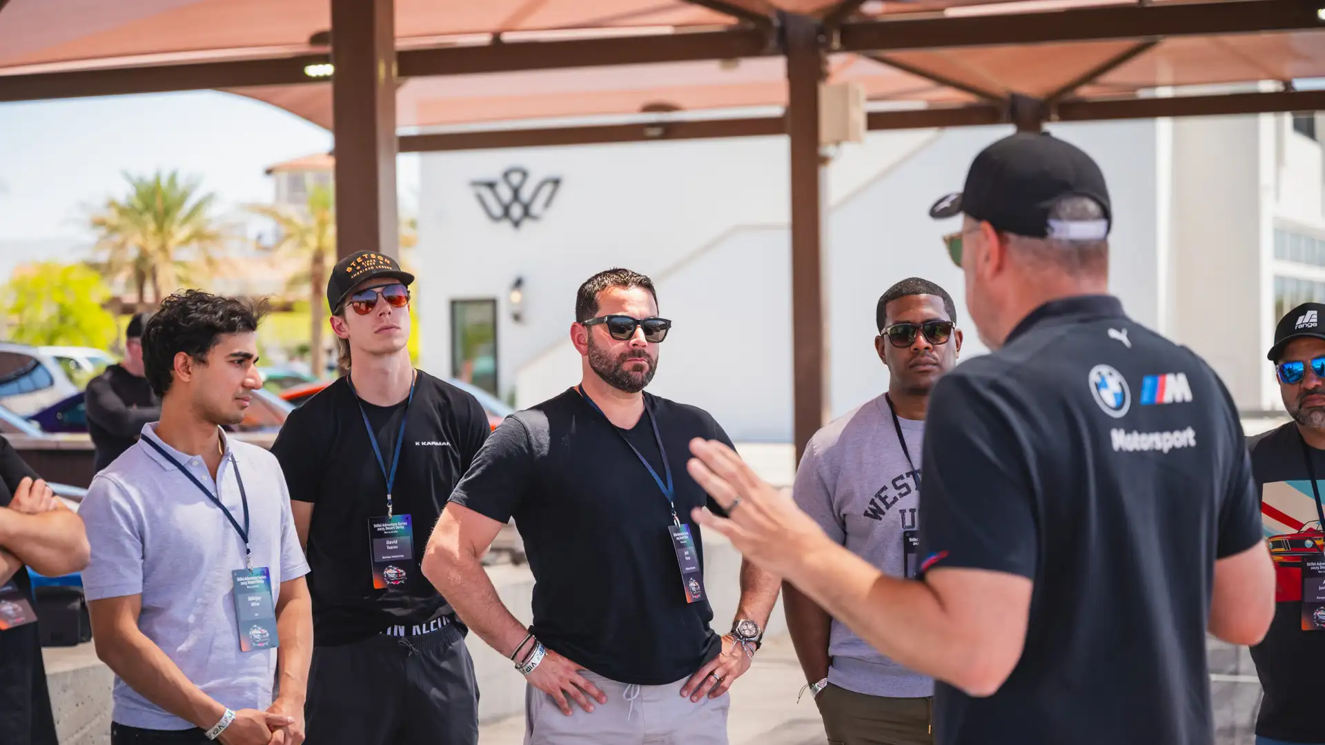 Instructor briefing a group of participants under the paddock canopy