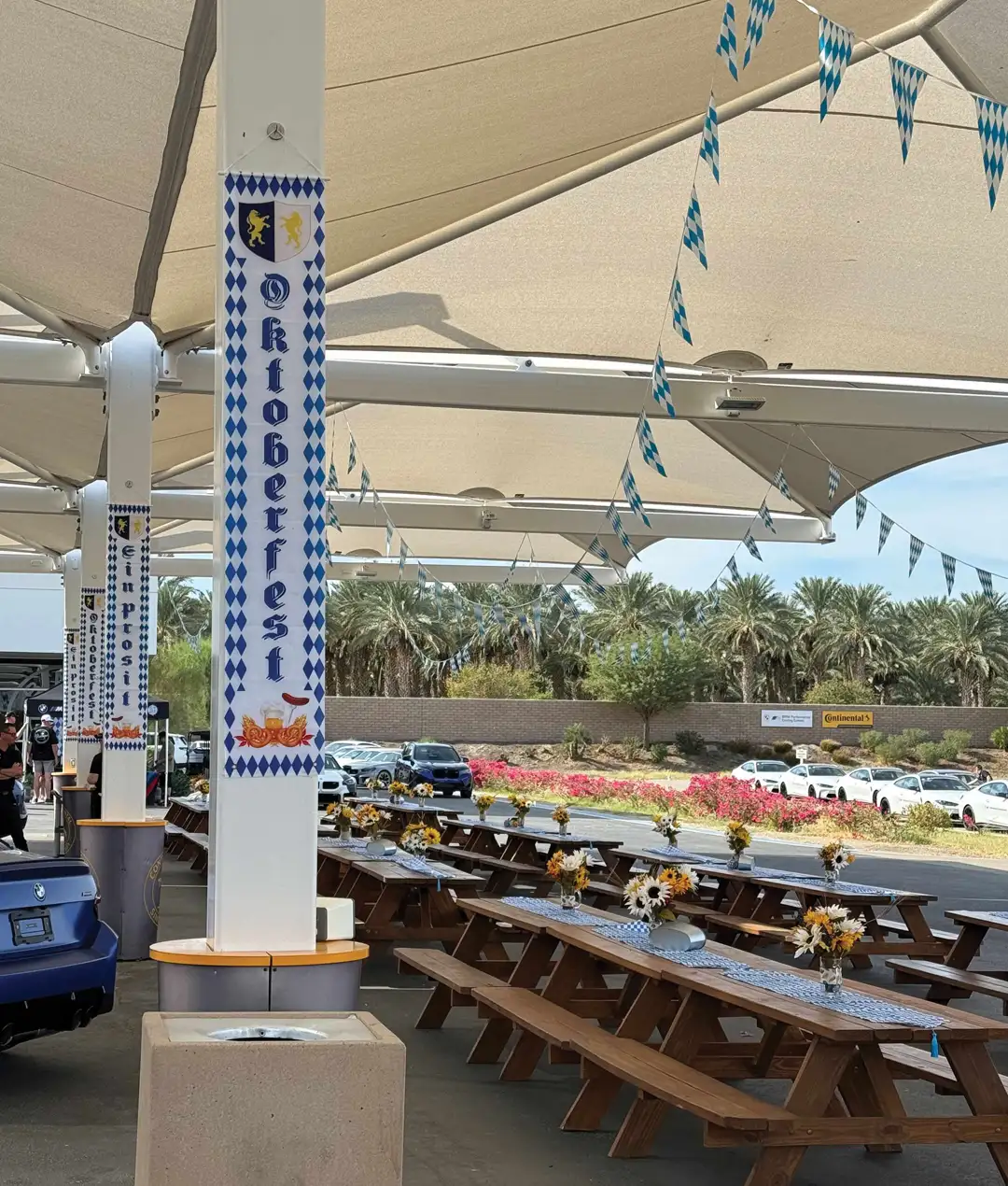 Oktoberfest banners and picnic tables under the canopy at the Performance Center