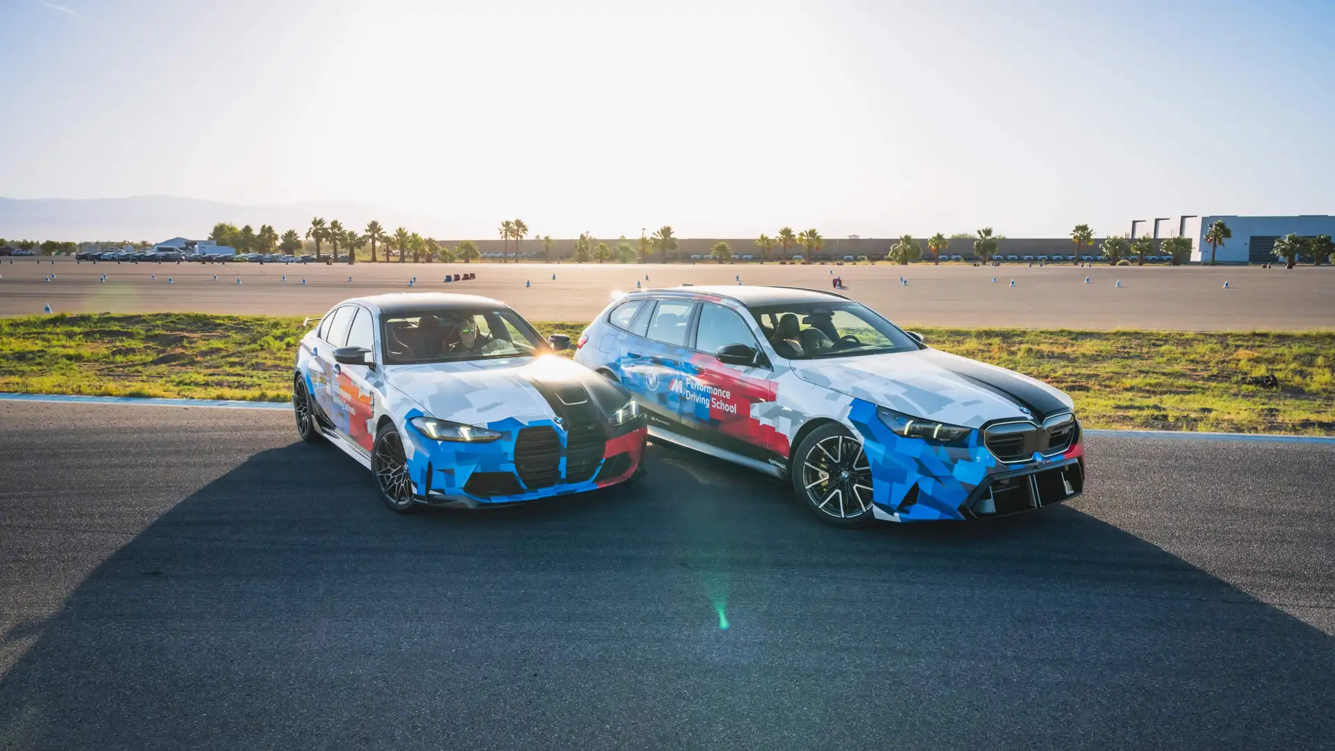 BMW M3 and M5 Touring in Motorsport livery parked side by side on the apron
