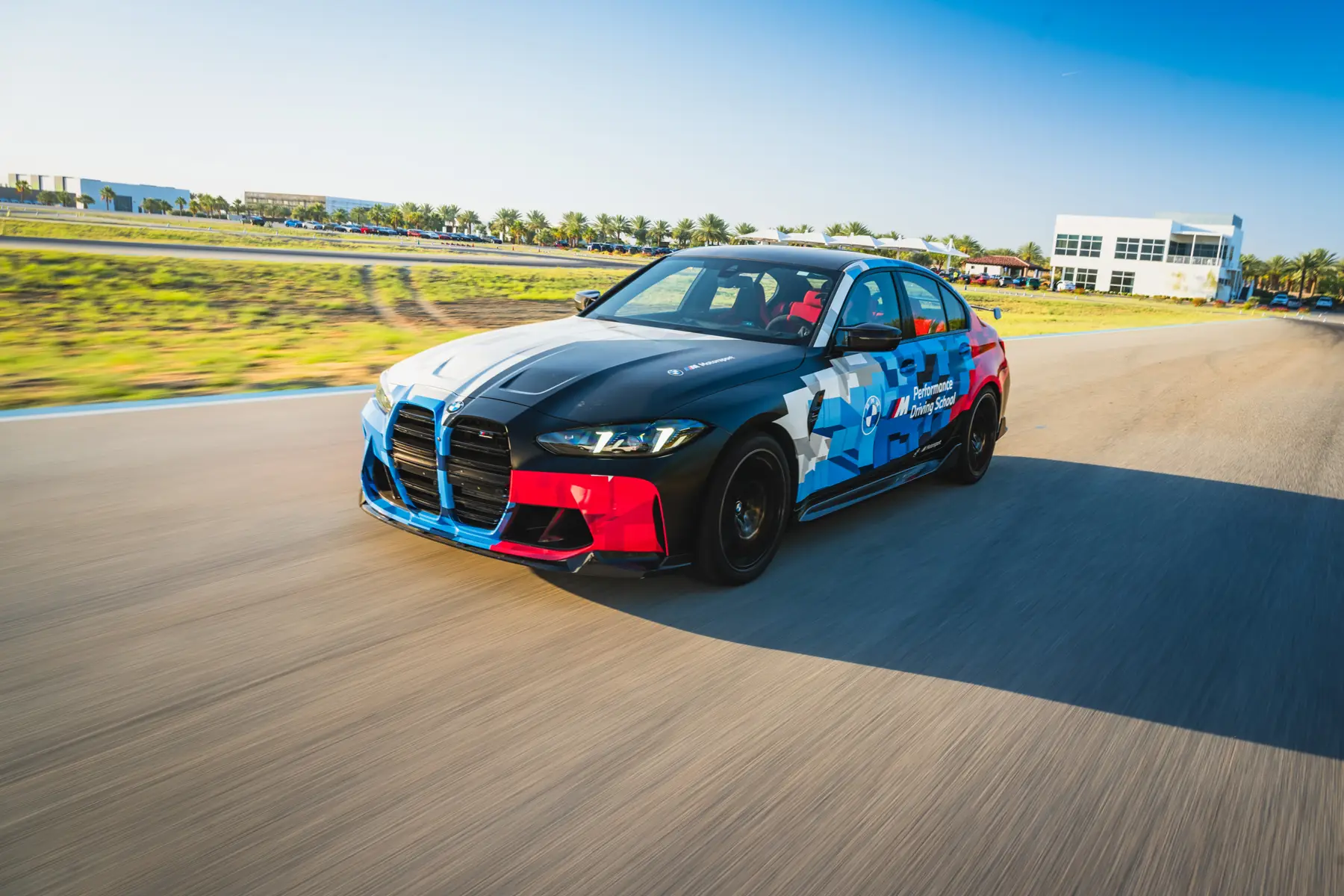 BMW M3 in Motorsport livery cornering on the desert circuit