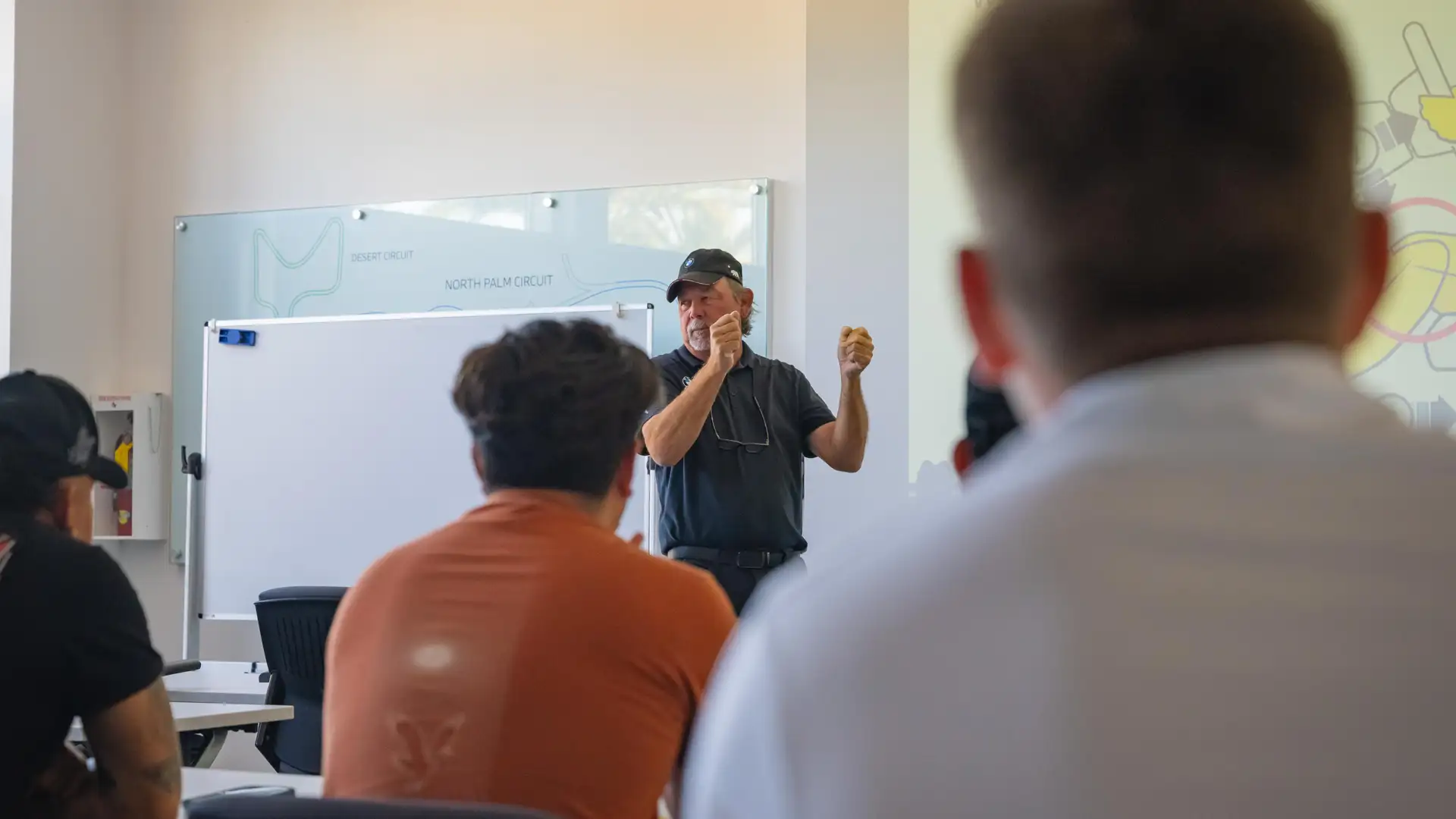 Instructor explaining the circuit layouts on a whiteboard track map