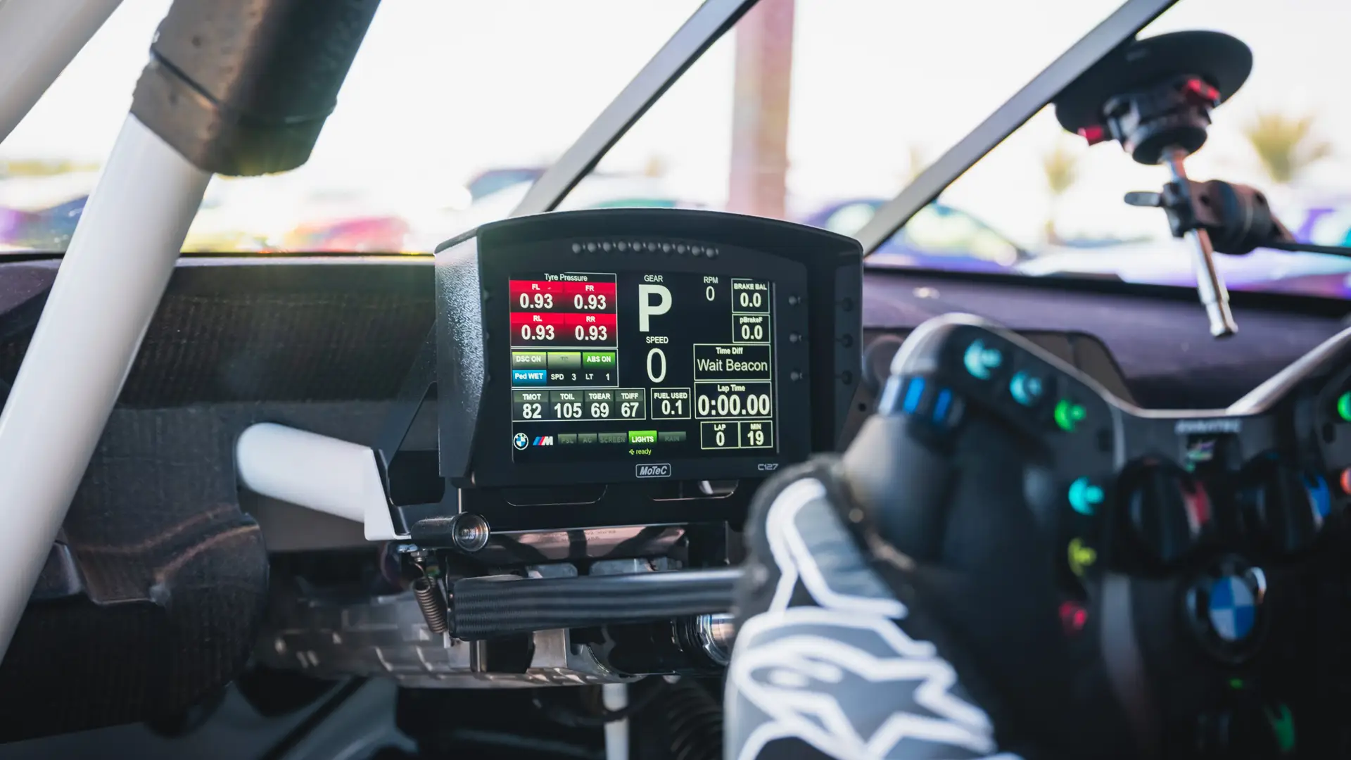 MoTeC data display and racing steering wheel inside the BMW M4 GT4 cockpit