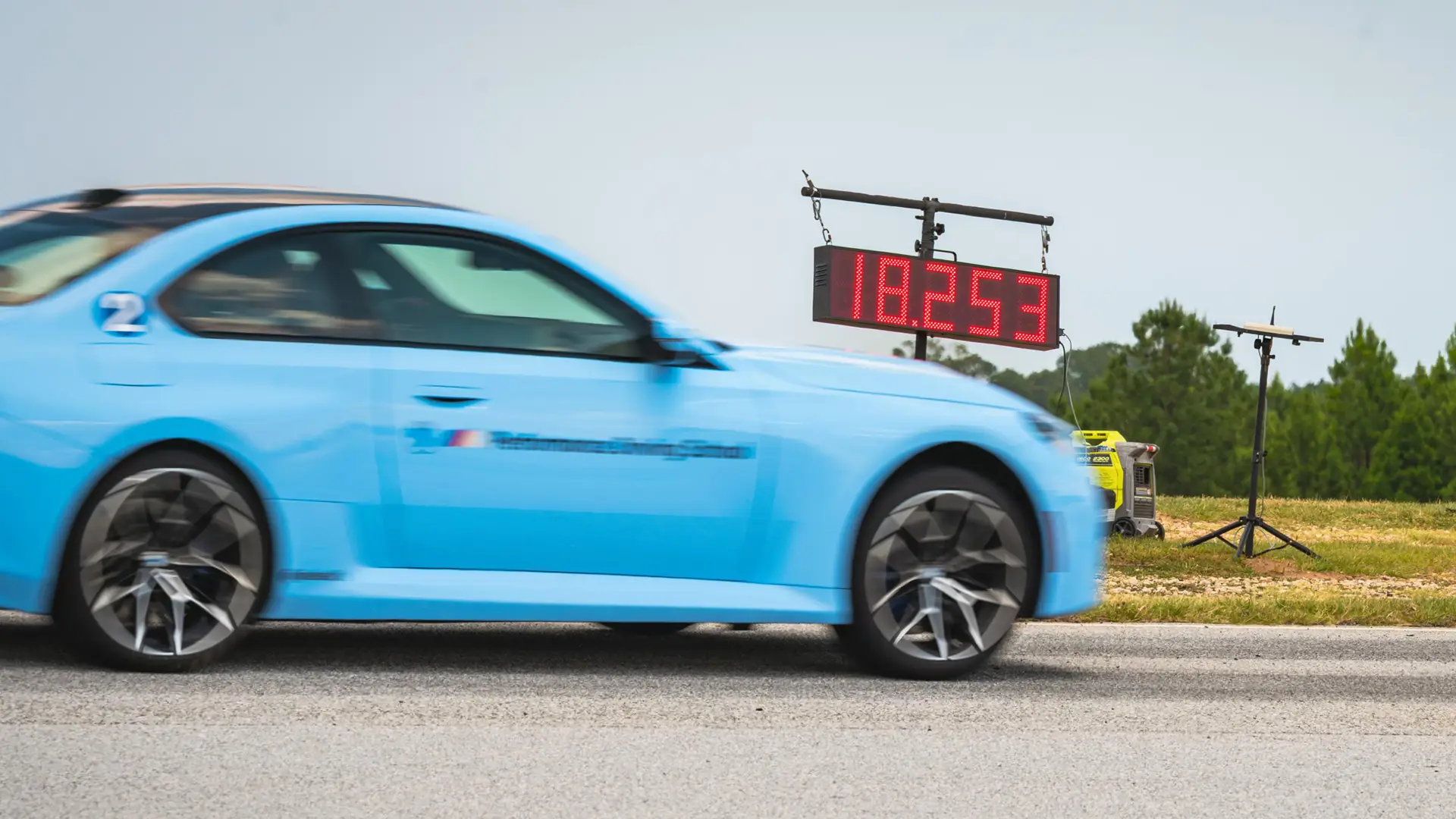 Light blue BMW M2 crossing the line as the timer reads 18.253
