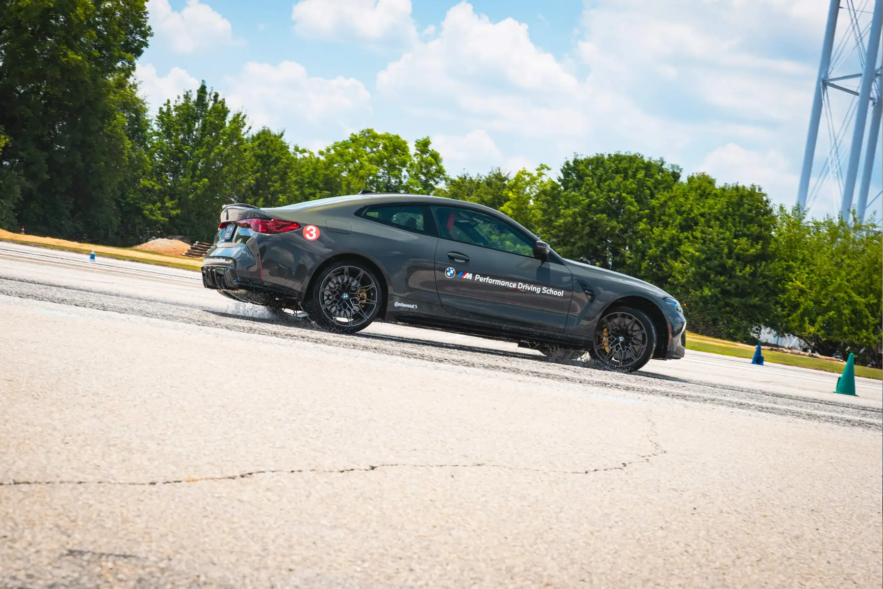 Grey BMW M4 on a coned exercise pad