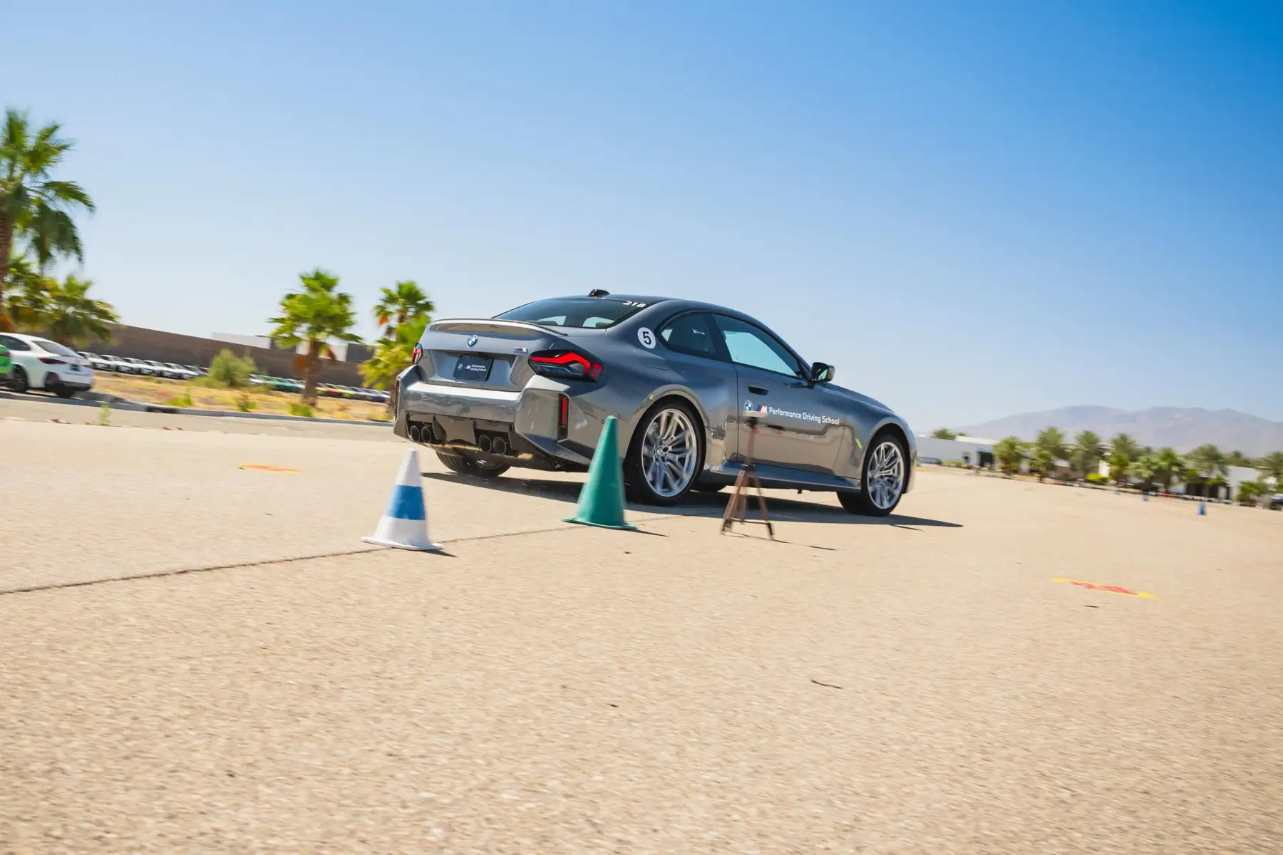 Grey BMW M2 on a coned course in the desert paddock