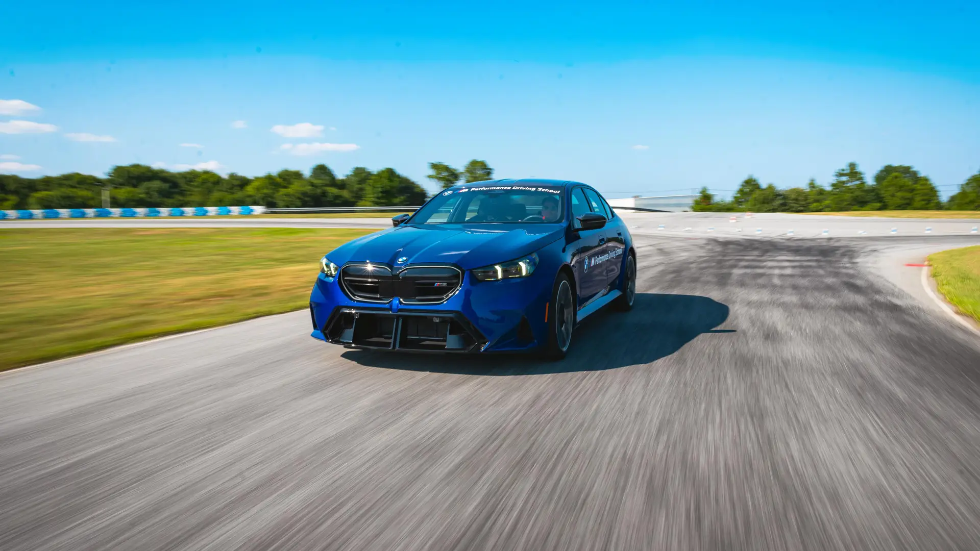 Blue BMW M5 at speed on the South Carolina circuit