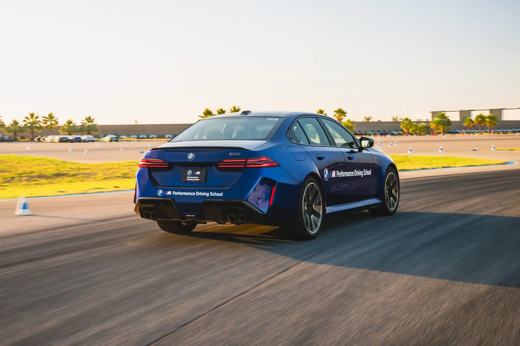 Blue BMW M5 accelerating away along the circuit