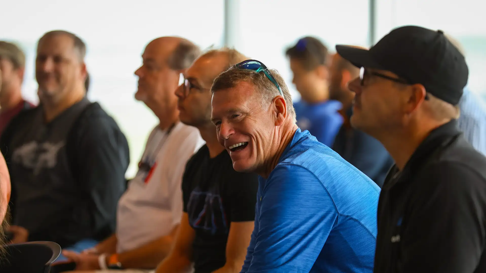 Participants laughing during a trackside briefing