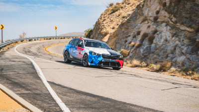 BMW M5 Touring in Motorsport livery on a desert mountain road