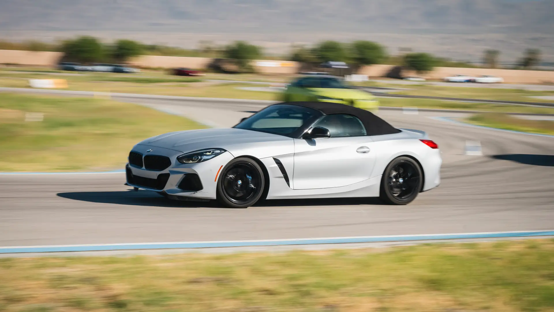 Silver BMW Z4 at speed on the desert circuit