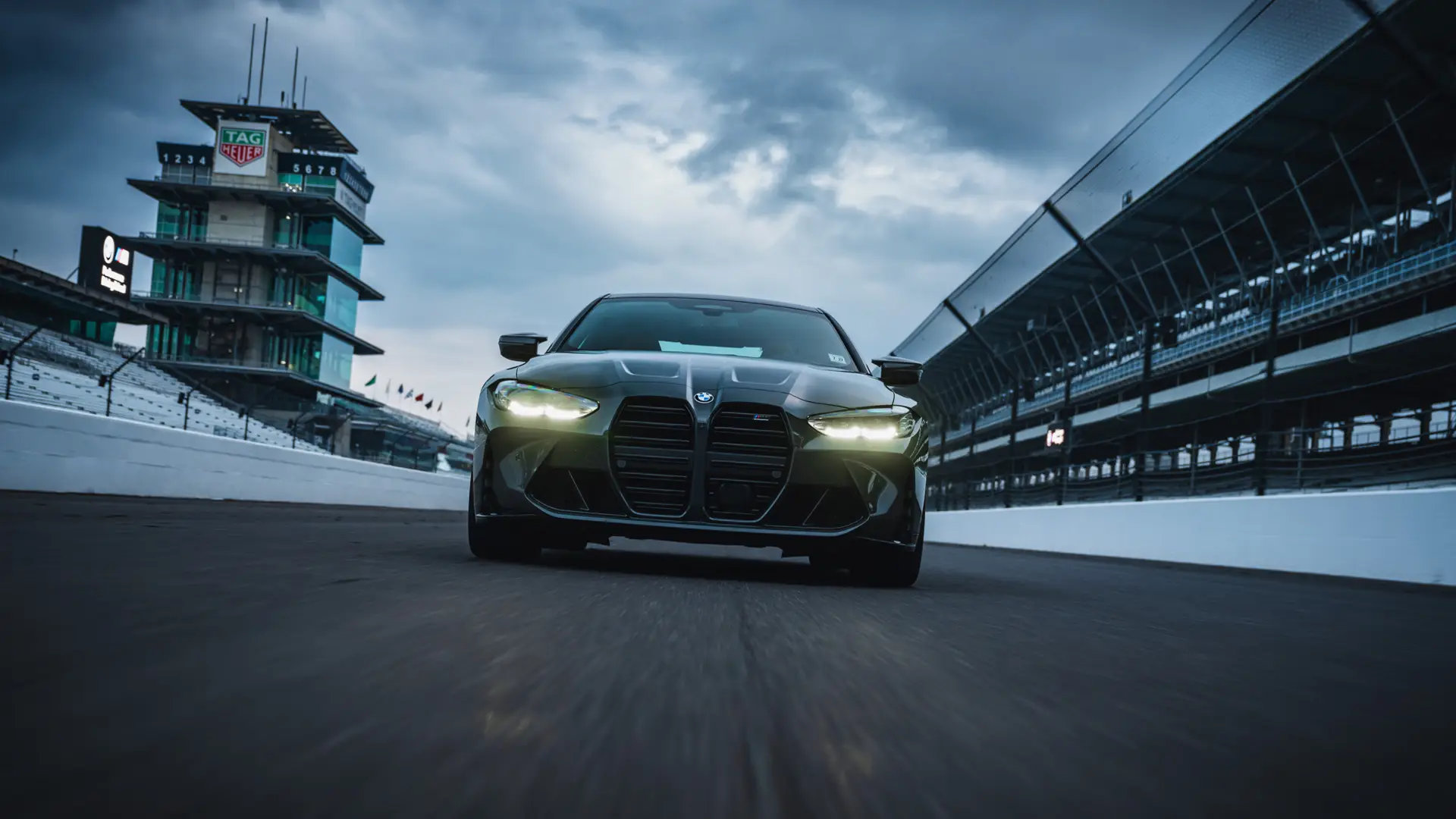 Dark BMW M4 on the front straight at Indianapolis Motor Speedway
