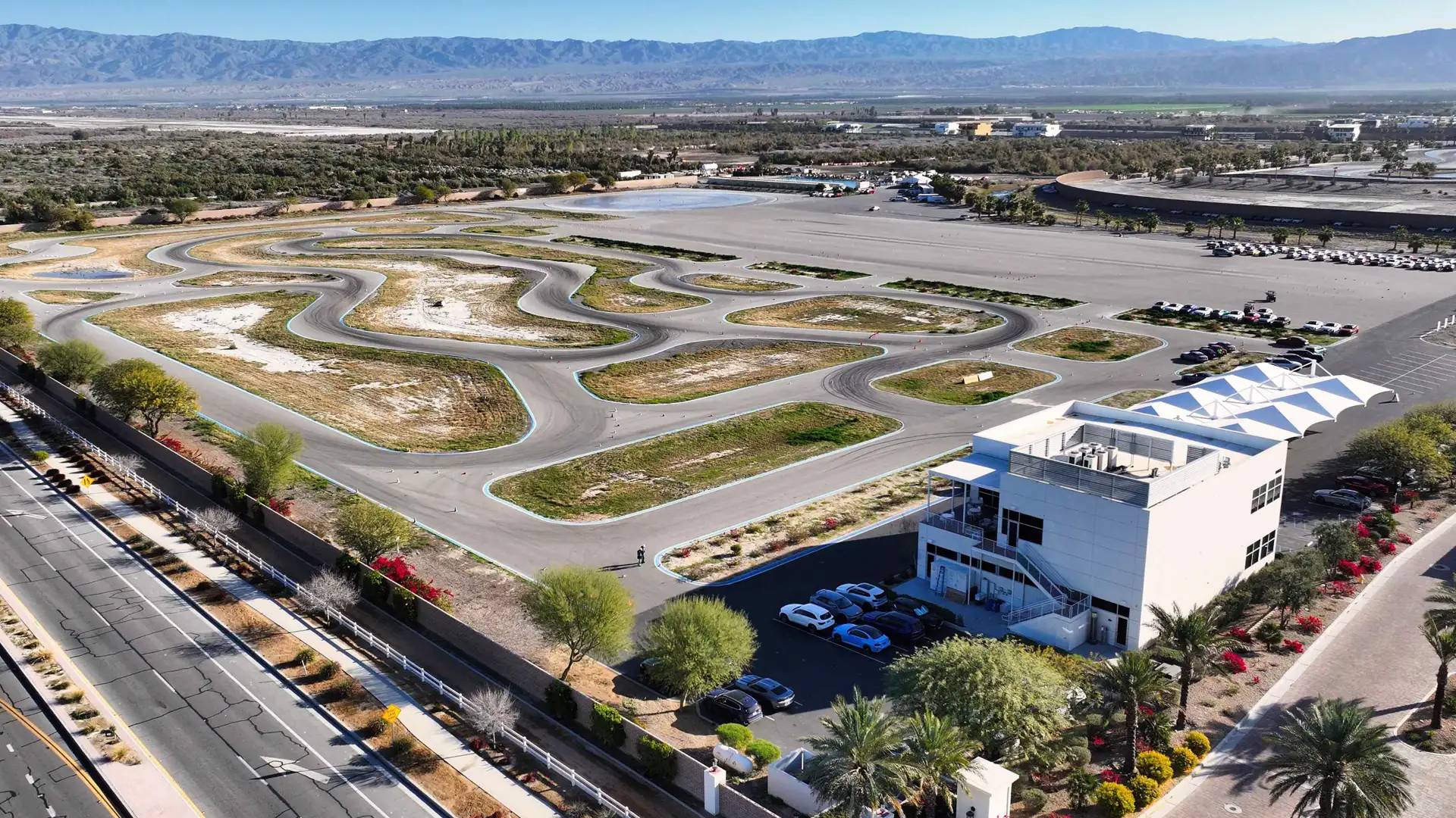 Aerial view of the winding desert circuit and the BMW Performance Center West building at The Thermal Club