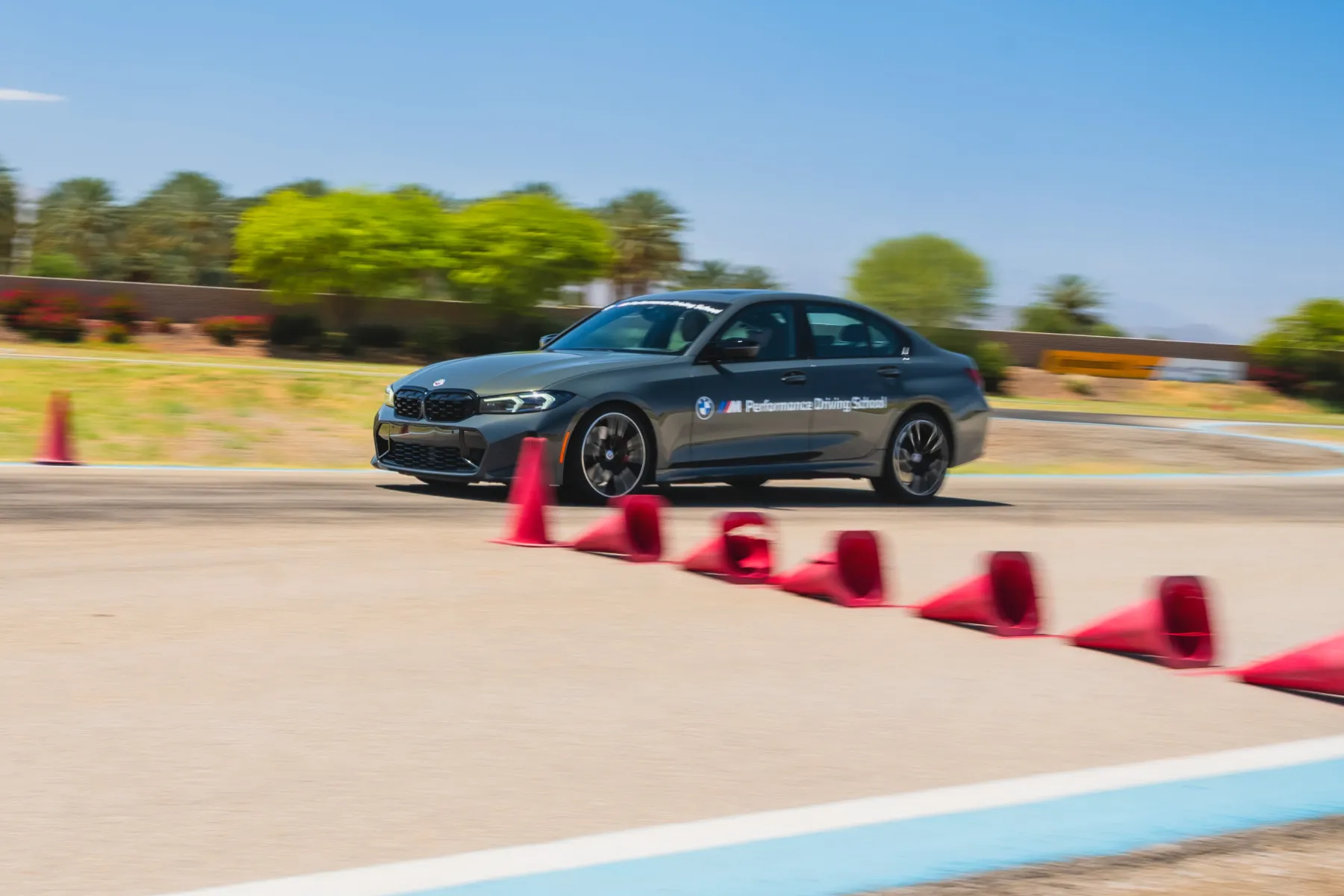 Grey BMW M340i running a coned course on the desert circuit