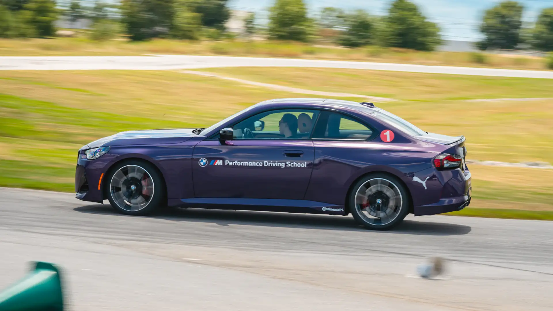 Purple BMW M2 at speed on the South Carolina circuit