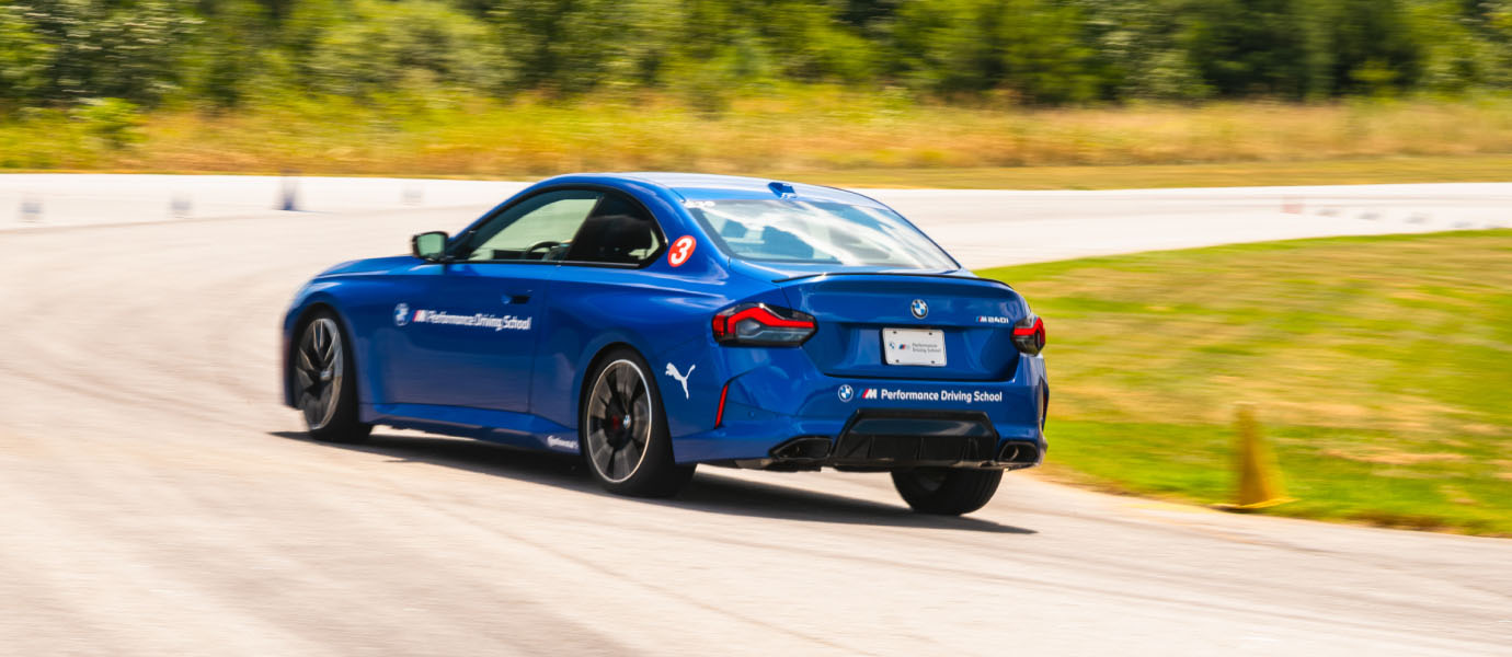 Blue BMW M240i cornering on the South Carolina circuit